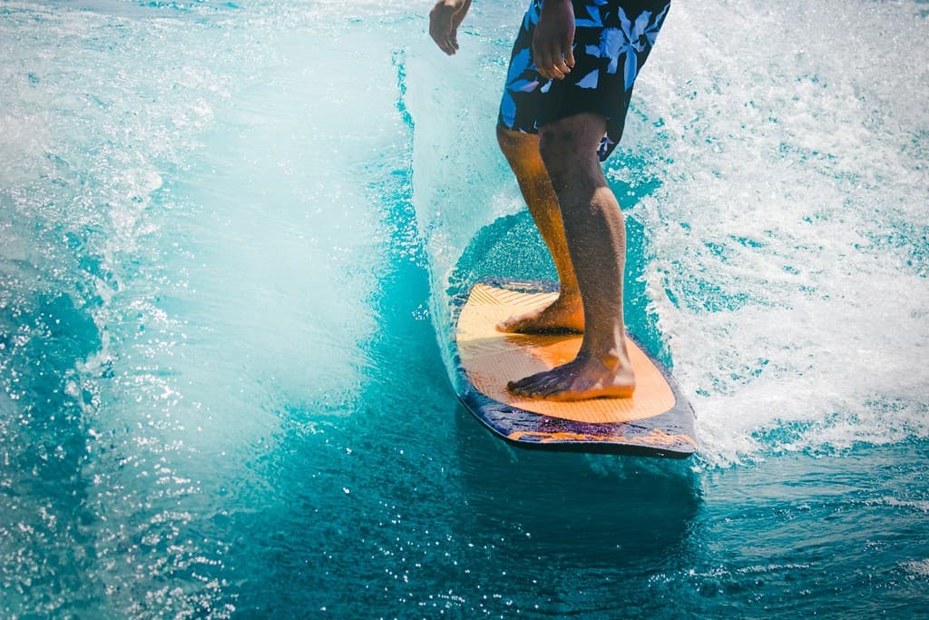 Group walking with surfboards on the beach